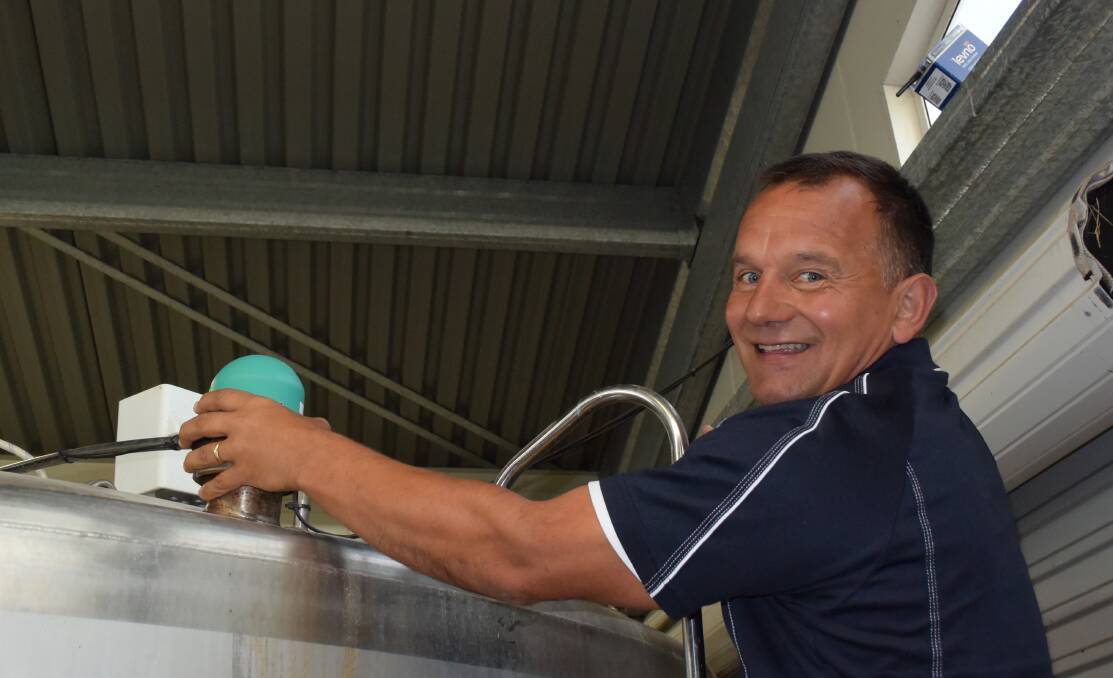 Levno national sales manager Shane Parlato with a monitoring unit on a milk vat. Bluetooth beams information through a network connected system to a smart device.
