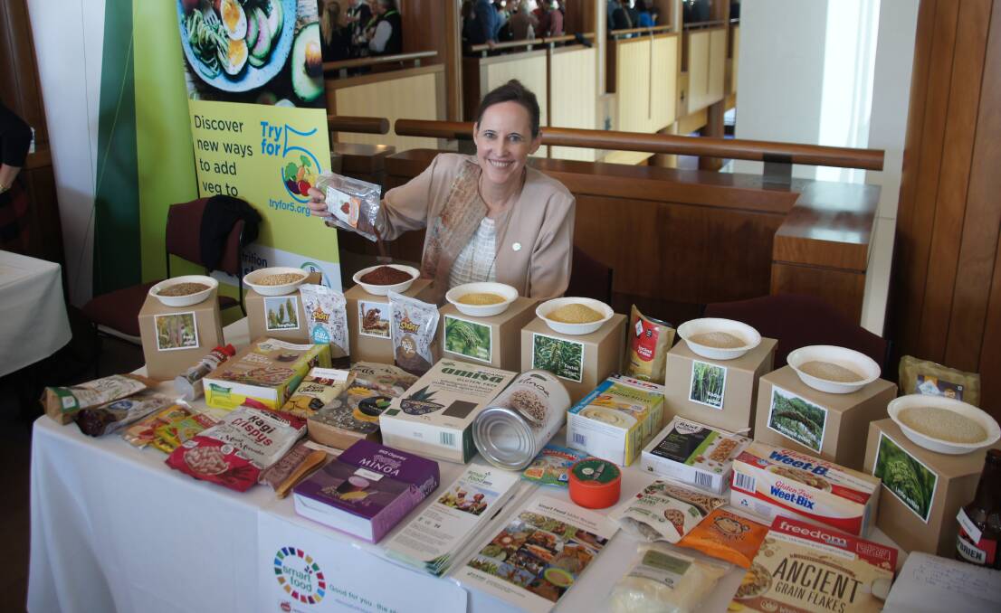 ICRISAT assistant director general Joanna Kane-Potaka with a collection of Smart Foods made of sorghum and millet at the Crawford Fund annual conference in Parliament House, Canberra.
