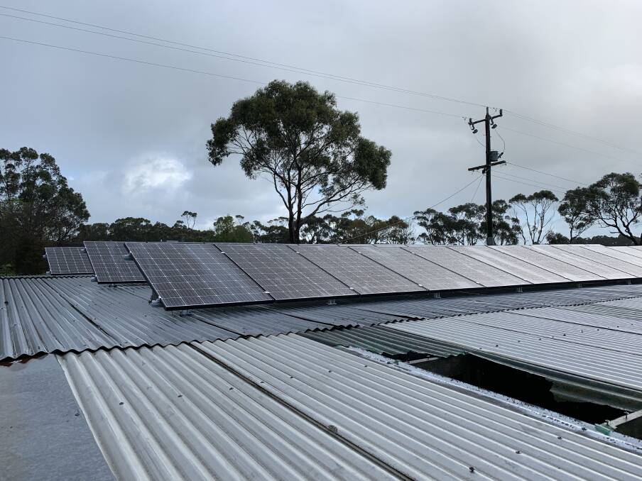 LOOKING UP: Solar panels on the roof of a shed and on a disused dairy are part of a 36 kilowatt and a 10KW power-generating configuration.