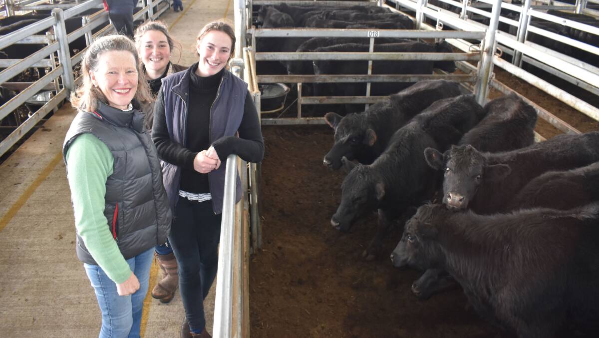 Georgie Evans, Derrinallum (right), selling her first ever cattle at Mortlake, had the support of Prue Evans, Hamilton, and Georgia Lillie, Larralea. Photo by Alastair Dowie.