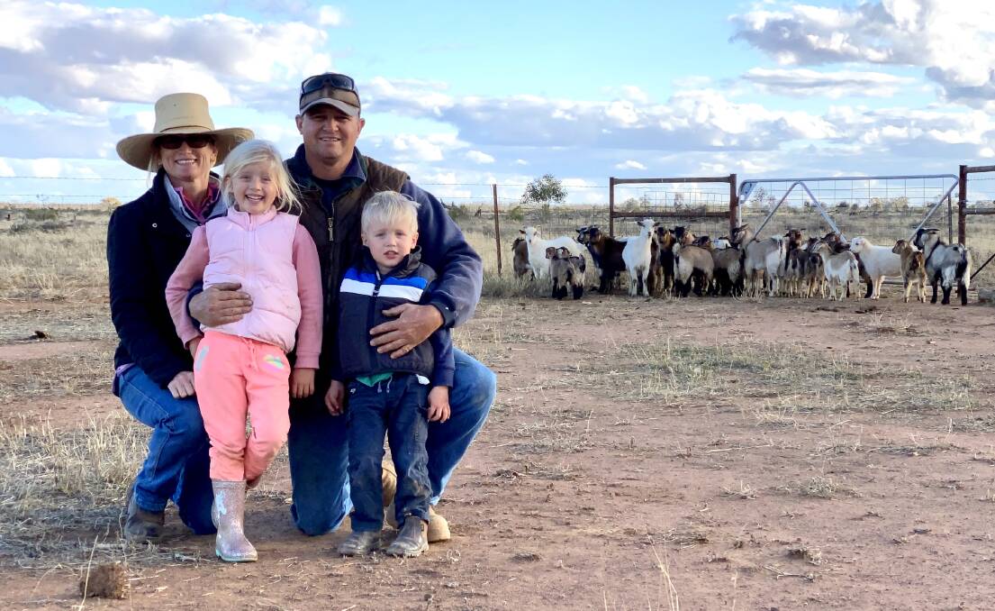 Amy, Caitie, Reggie and Bob Brown, Bollon, Qld, with some underweight goats in the background.