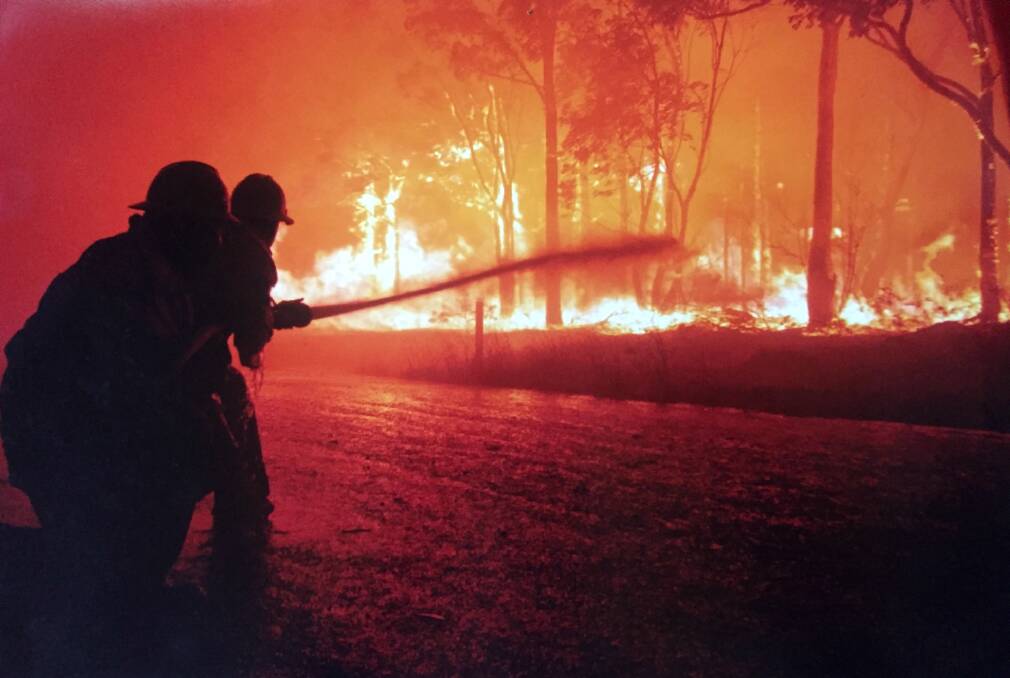 RED ALERT: Firefighters tackle a blaze on Depot Road West Nowra more than a decade ago. The street was recently under threat once again this year. Photo ADAM WRIGHT