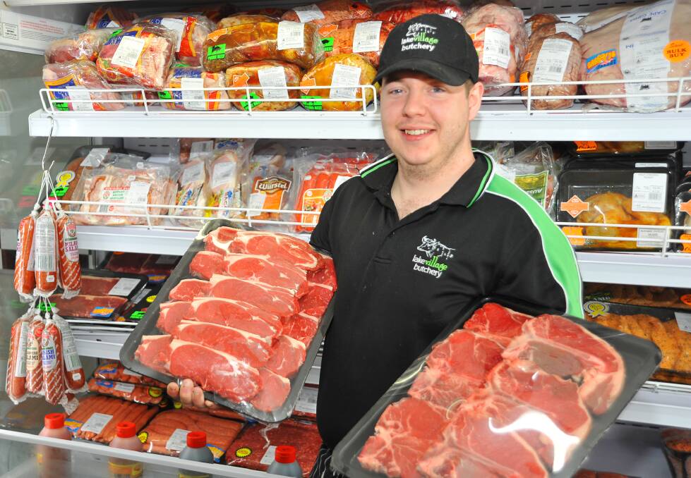 DINNER SORTED: Butcher Joshua Watson holds up some steak trays at Lake Albert. Picture: Supplied