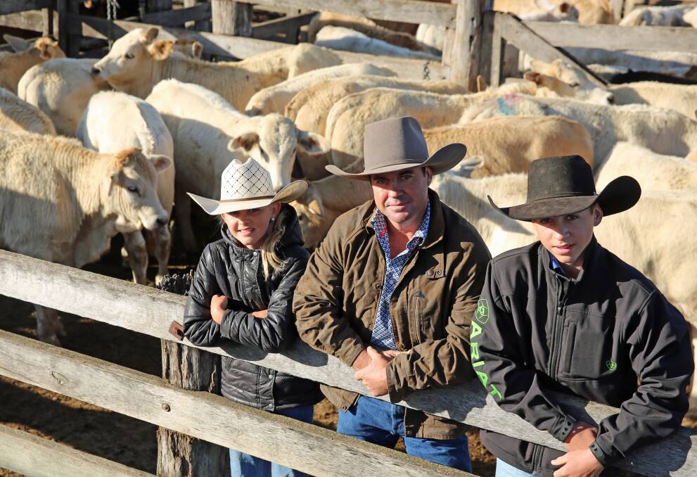 Holly, Bruce and Todd Myers, South Kolan, with a pen of the Myers family Charolais cross steers. The steers sold for 396.2c/kg or $990.50/head.