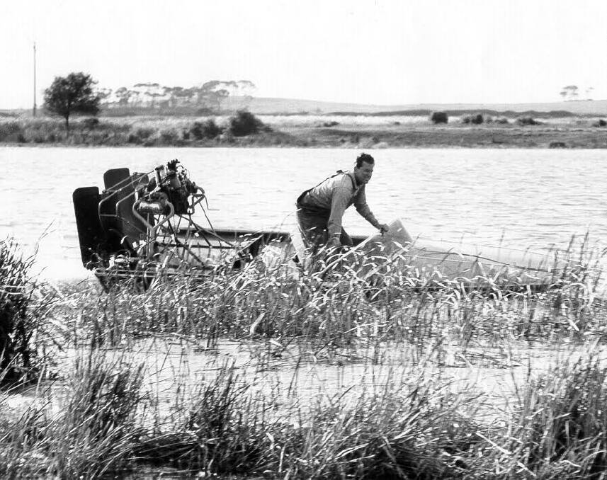 Peter Grundy driving a VW motored airboat along Holmes Creek.