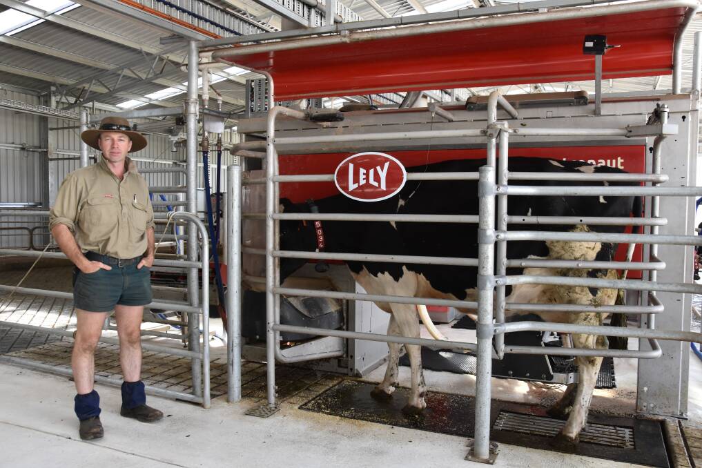HIGH-TECH: Dairyfarmer Josh Clark with one of the Lely robotic milkers, which has provided him and his family with a wealth of usable data.
