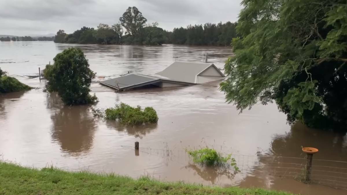 A house floats down the Manning River at Tinonee in the March 2021 floods. 
