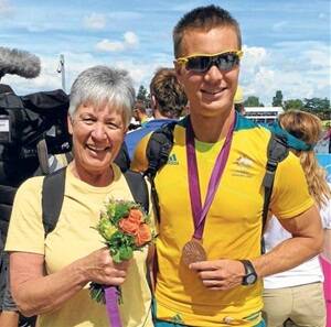 Chris McRae receives a special posy from her son James after the Olympic quad sculls medal ceremony in London.