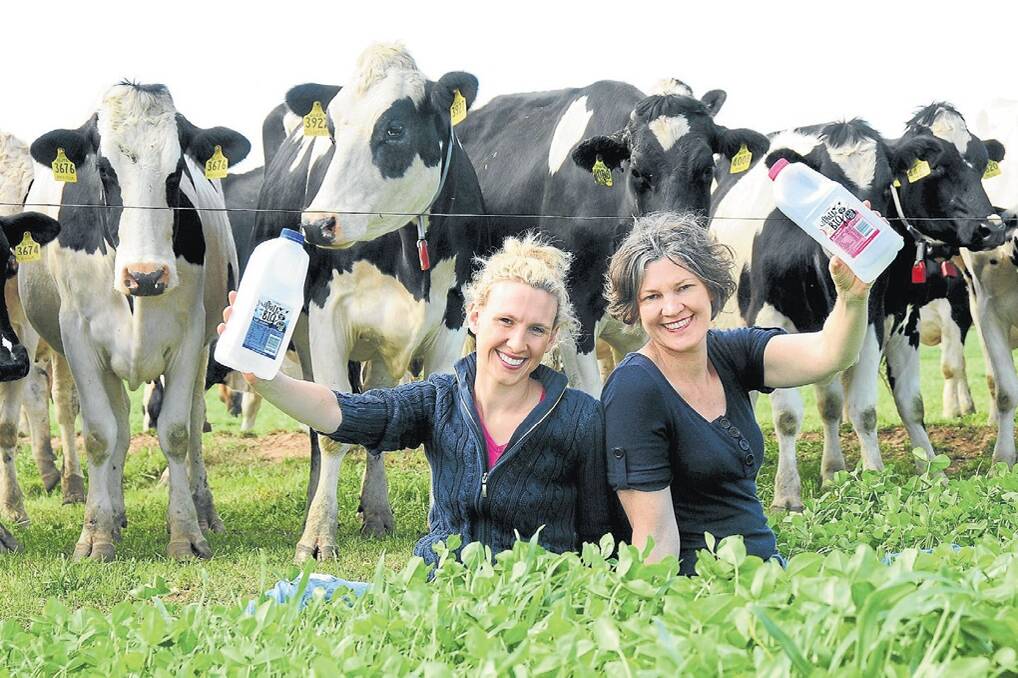Emma Elliott and her mother Erika Chesworth out with the cows on the Little Big Dairy Company, Rawsonville near Dubbo. Photo Louise Donges