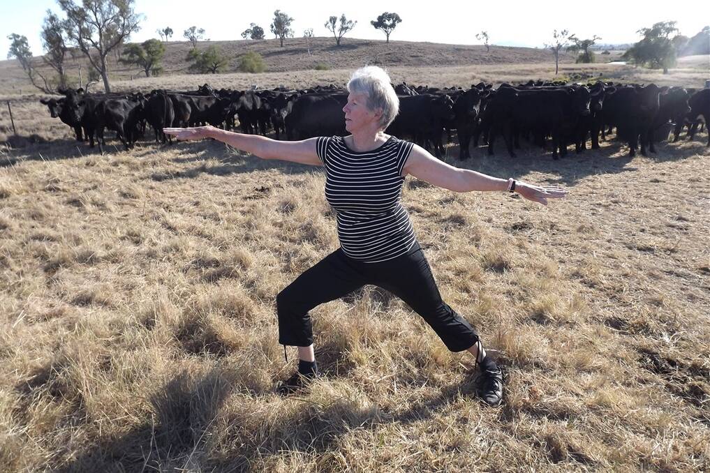 Bronwen practising her passion for yoga out in the long paddock with her Angus breeders.