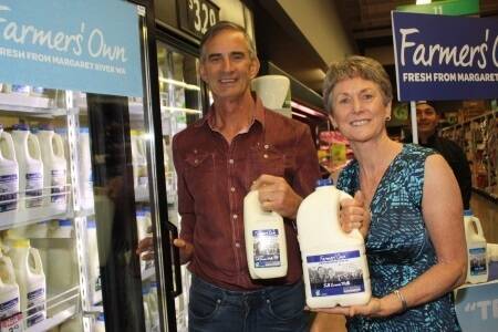 Woolworths Farmers' Own milk suppliers Ian and Helen Noakes with the milk on offer in 89 WA stores.