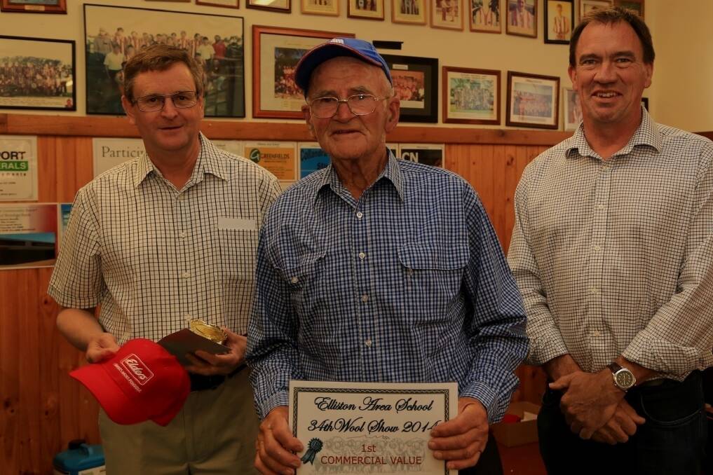 FINE WORK: Elders Port Augusta's Charlie Rowe, commercial fleece winner Peter Henderson, Elliston, and  Member for Flinders Peter Treloar.
