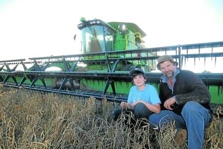 Chris Taylor, Taylor Ag and Pastoral Company, Dubbo, with his son, Lorcan, 9, harvesting adzuki beans at "Terrabella", Dubbo, for the Stevenson family.