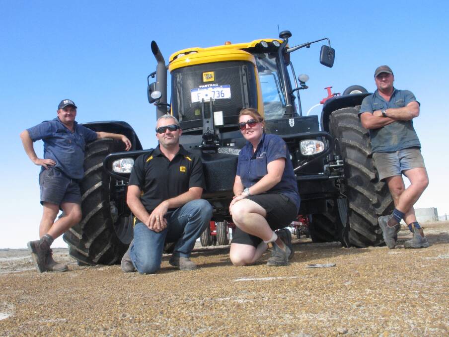 This new JCB 8310 Fastrac tractor on three metre spacings is one of three to be employed this year on Kym and Daren Curnow's property at Scaddan. Pictured here are from left, Kym Curnow, Staines Esperance salesman Dale Guest, tractor driver Kirby Maher and Daren Curnow.