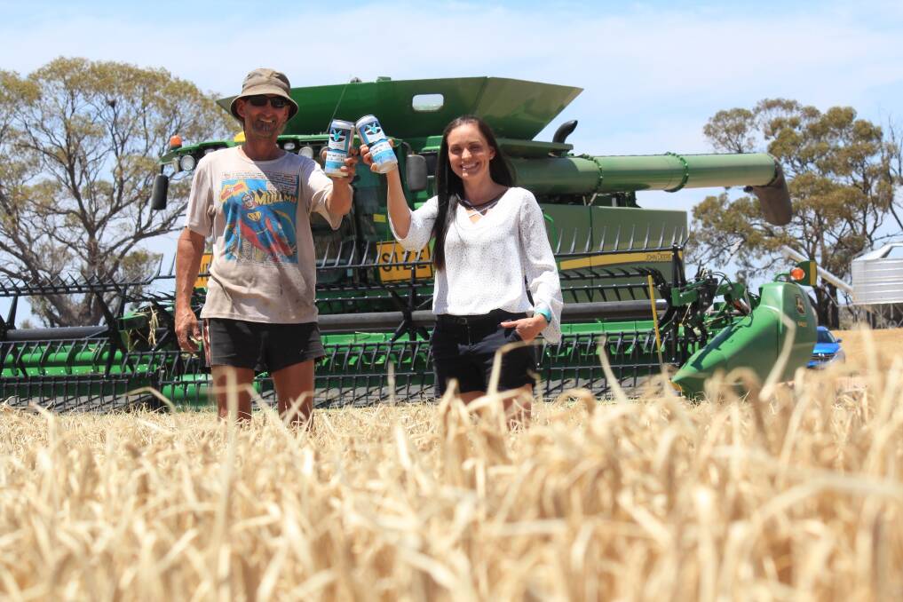 Meckering Sporting Club president Jeff Snooke and local farmer Rebekah Burges toast using local Bass barley to produce a commemorative beer next year.