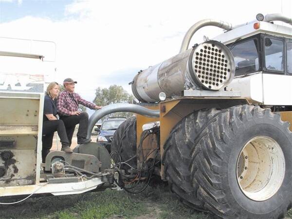 Cunderdin farmer Ian James, pictured with his wife Jodi, made this heat exchanger and designed the hose system for efficient transfer of the tractor's cooled exhaust emissions fertiliser.