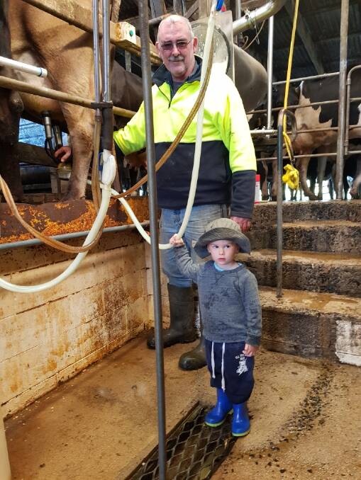 MILKING IT: Millaa Millaa dairy farmer James Geraghty, with grandson Charlie Daley, are calling for fair milk prices.