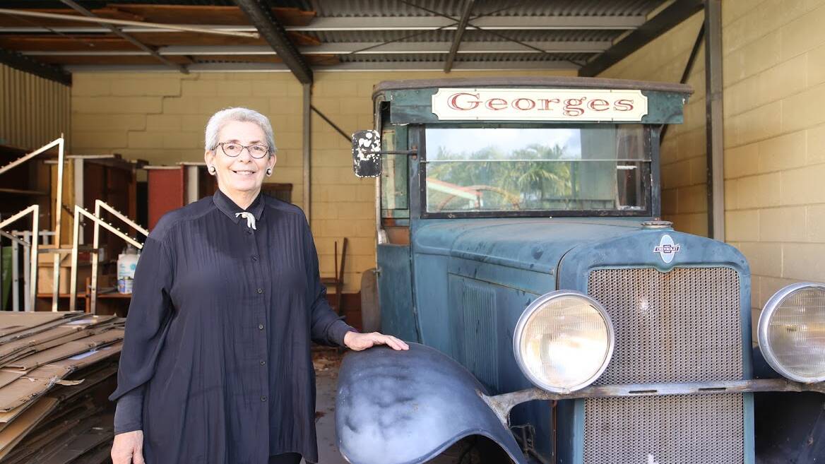 Catherine George with her grand fathers's 1929 Chev, which still takes pride of place at Georges Workwear and Country Outfitters.