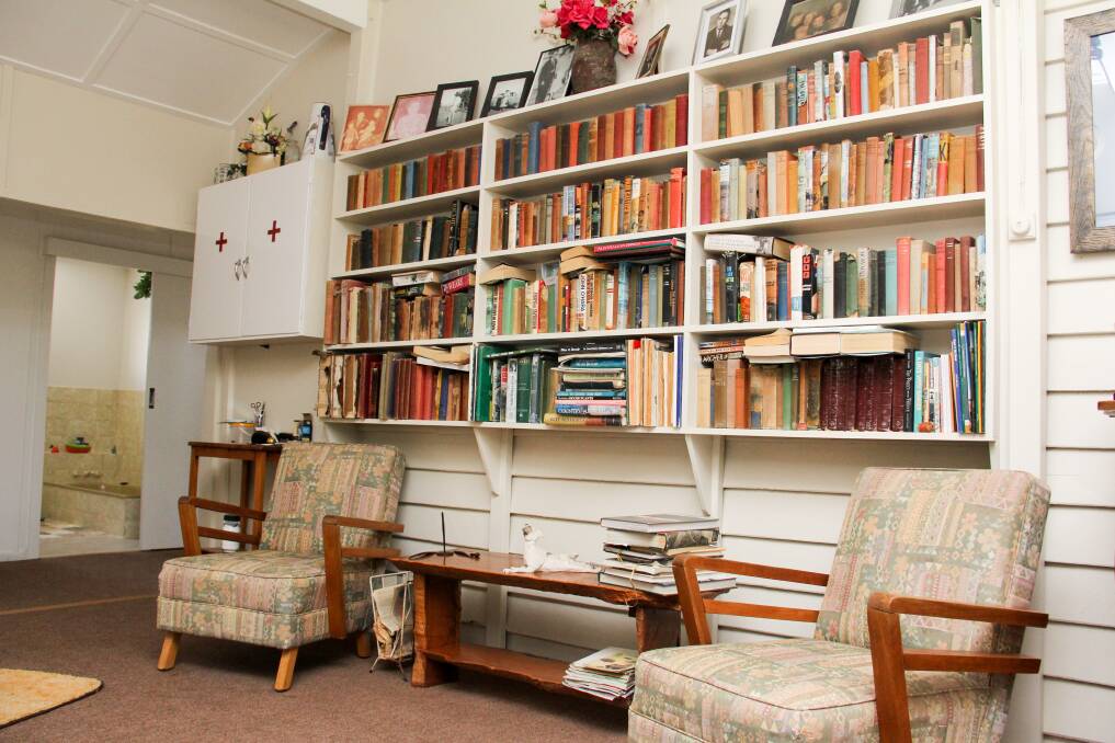 A bookshelf in the large sitting area that was once part of the open living timber verandah.
