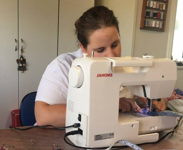 Hannah Bischoff busy sewing the capes for the toad race. 