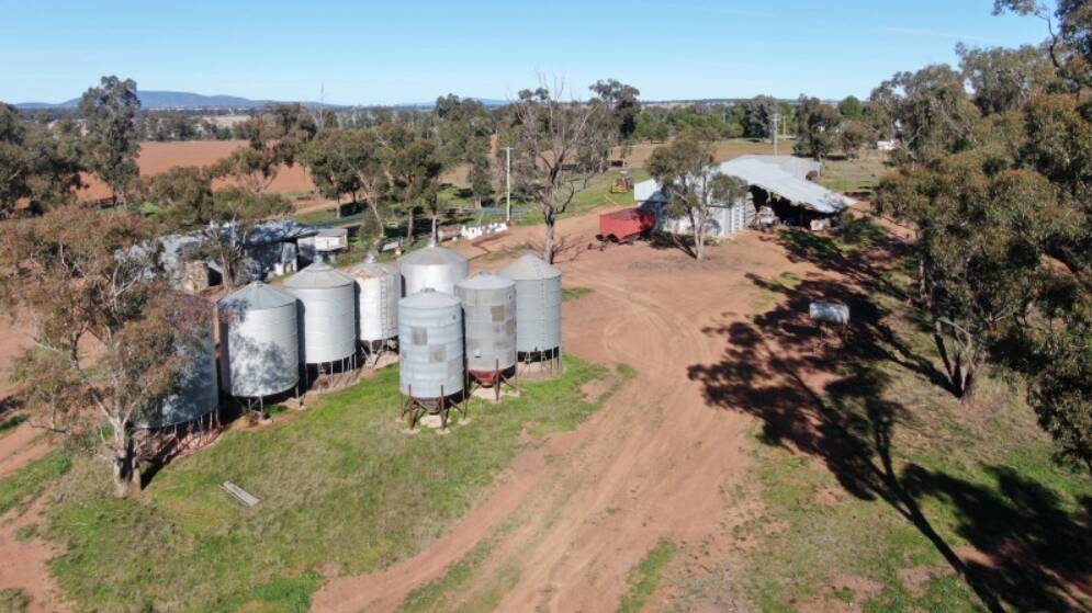 Infrastructure includes a two stand shearing shed, eight silos, a 350t capacity grain shed/machinery shed, and a second machinery shed.