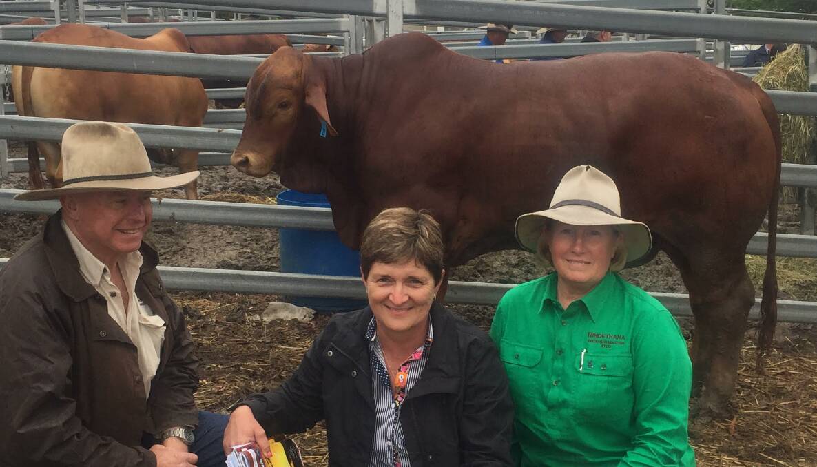 SALE TOPPER: Michael and Tracey Flynn, Valera Vale Droughtmasters, Milbong and Charleville, with Browyn Betts, Nindethana Droughtmasters, Camp Mountain, and the $25,000 top priced bull Nindethana Jean Valjean.