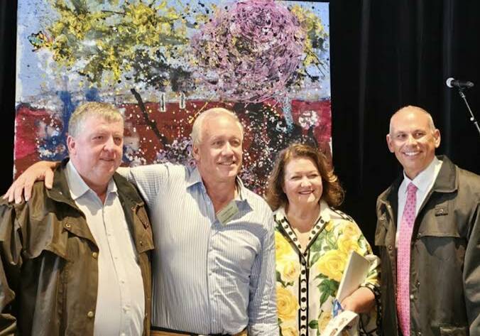 Artist Chick Olsson (second from left) with Dave Davies, Gina Rinehart and Adam Giles from Hancock Agriculture at the Rural Aid Long Lunch and a donated artwork that sold for $10,000 at the Rural Aid Long Lunch. 